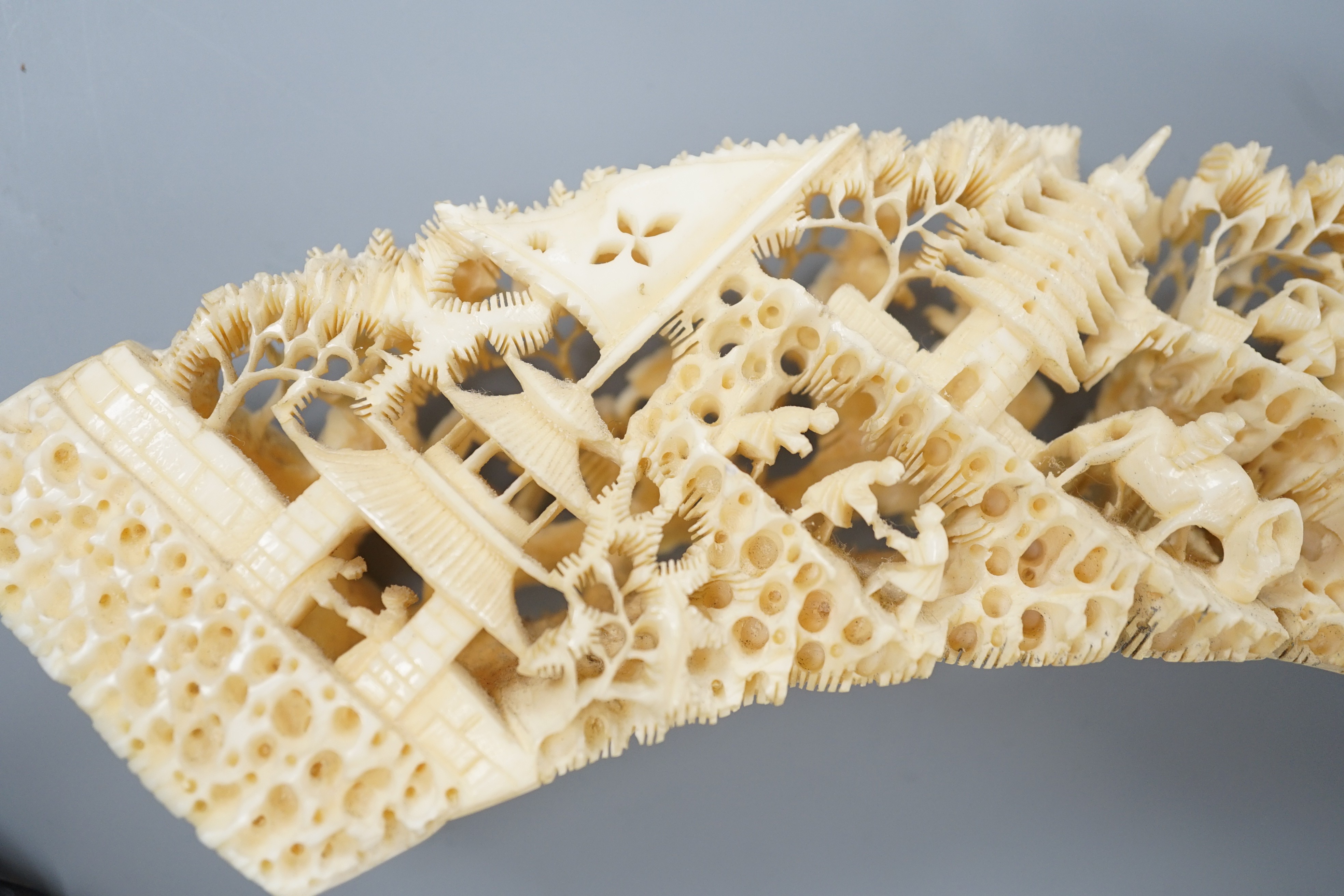 An early 20th century Chinese ivory ‘dragon’ box and cover, and a boar’s tusk carving of figures amid pavilions 40cm